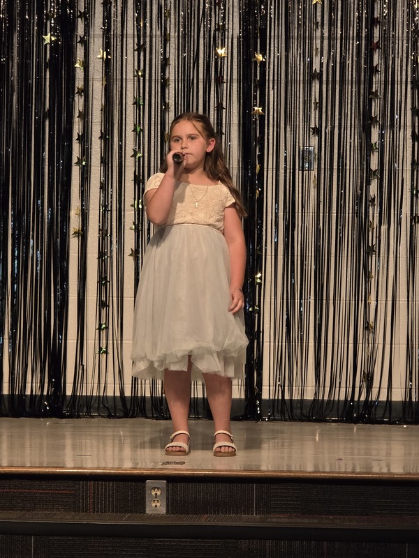 Students performing on stage.