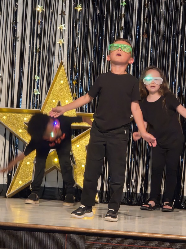 Students performing on stage.