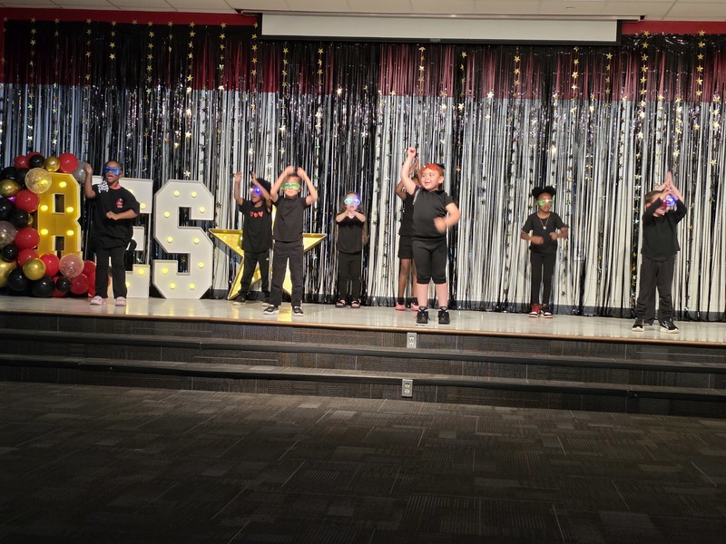 Students performing on stage.