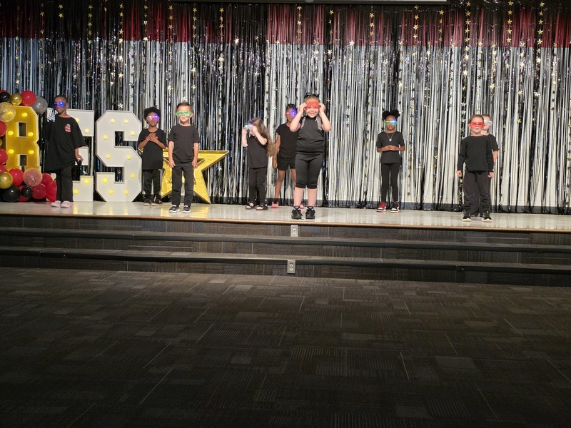 Students performing on stage.