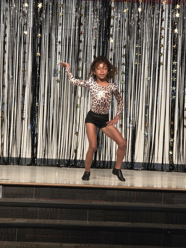 Students performing on stage.