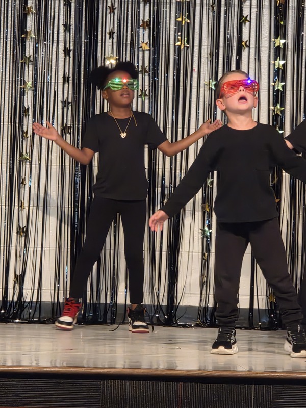 Students performing on stage.