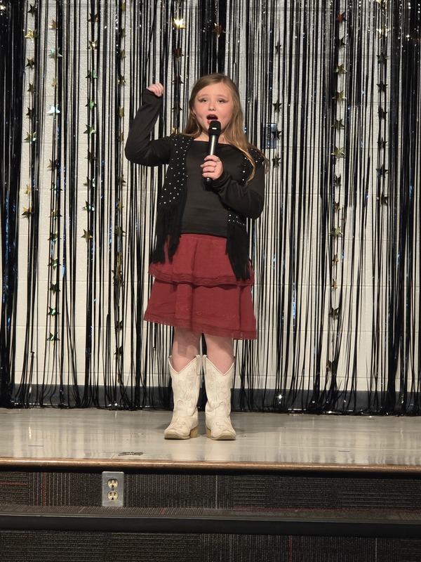 Students performing on stage.