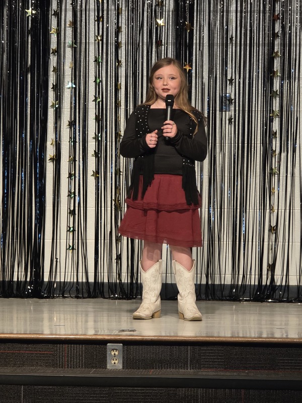 Students performing on stage.