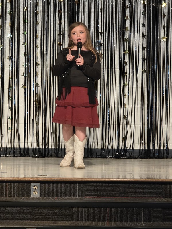 Students performing on stage.