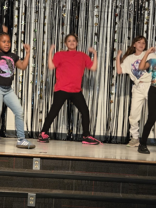 Students performing on stage.