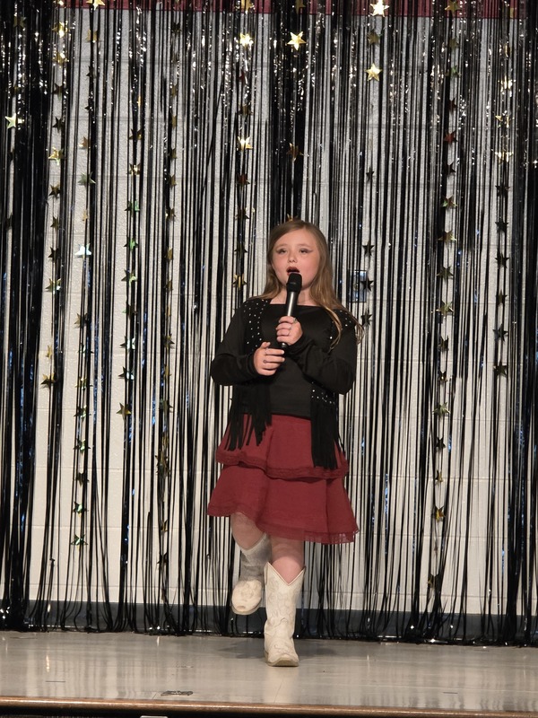 Students performing on stage.