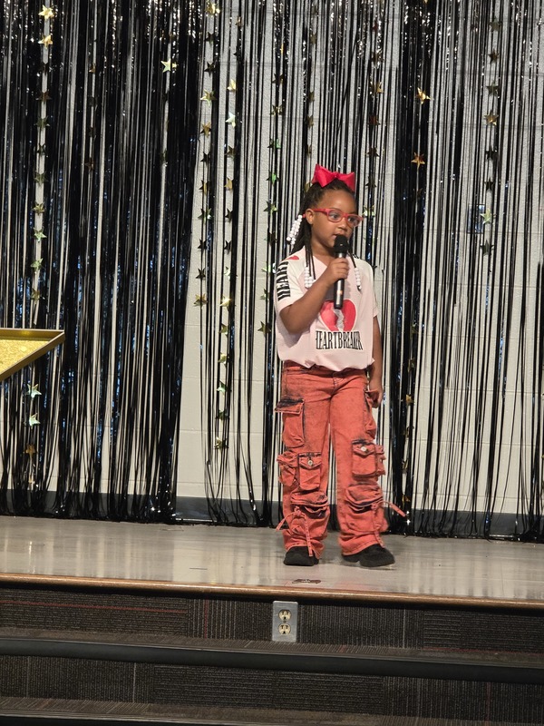 Students performing on stage.