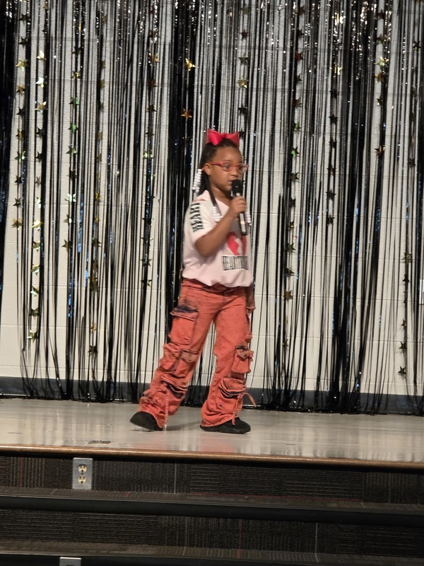 Students performing on stage.