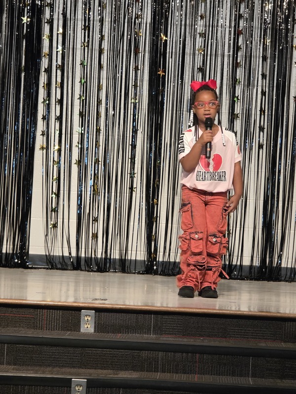 Students performing on stage.