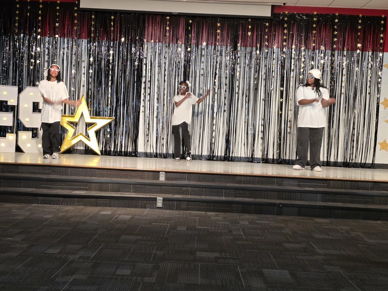 Students performing on stage.