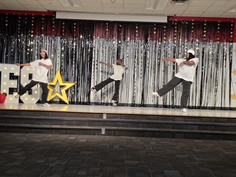 Students performing on stage.