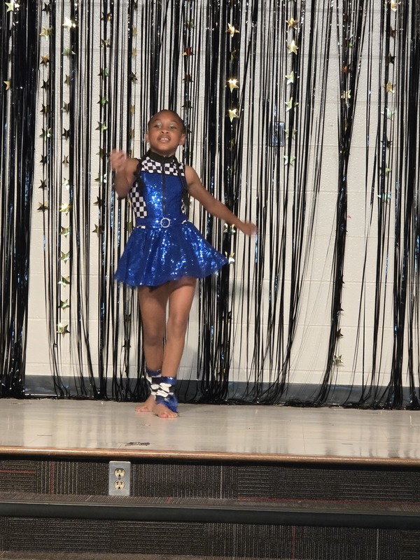 Students performing on stage.