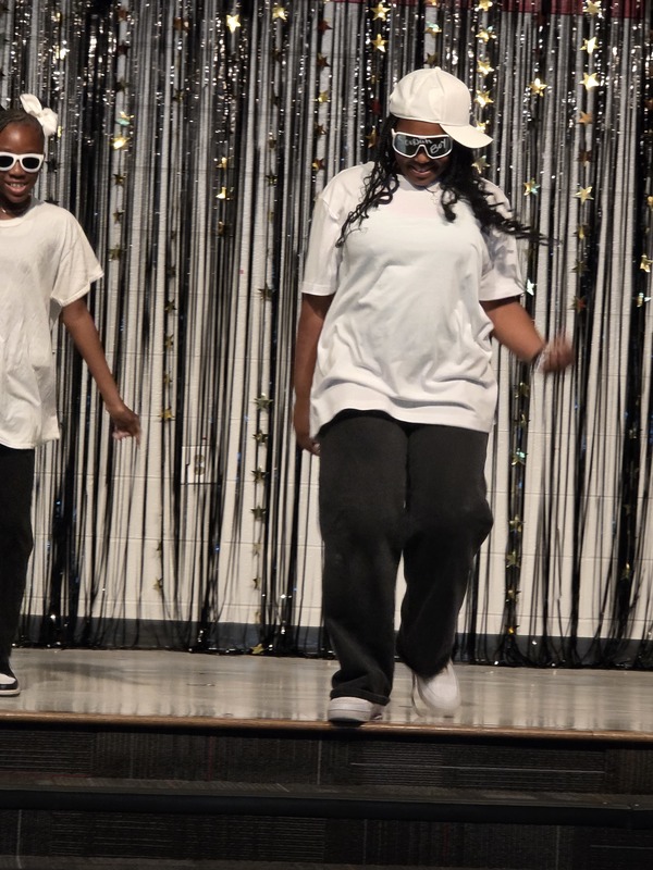 Students performing on stage.