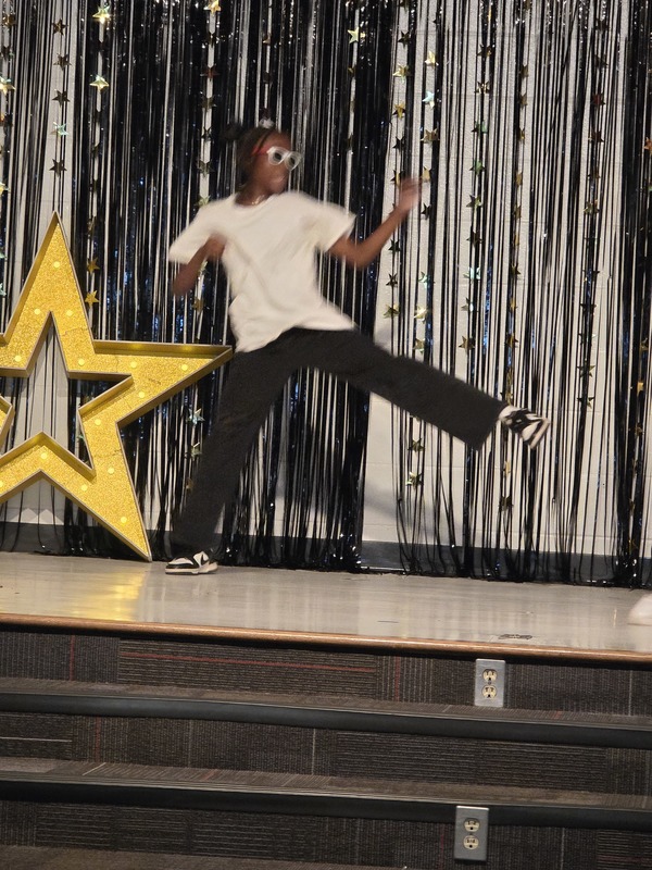 Students performing on stage.