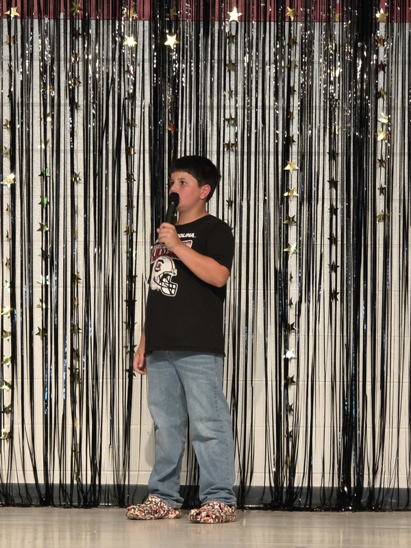 Students performing on stage.