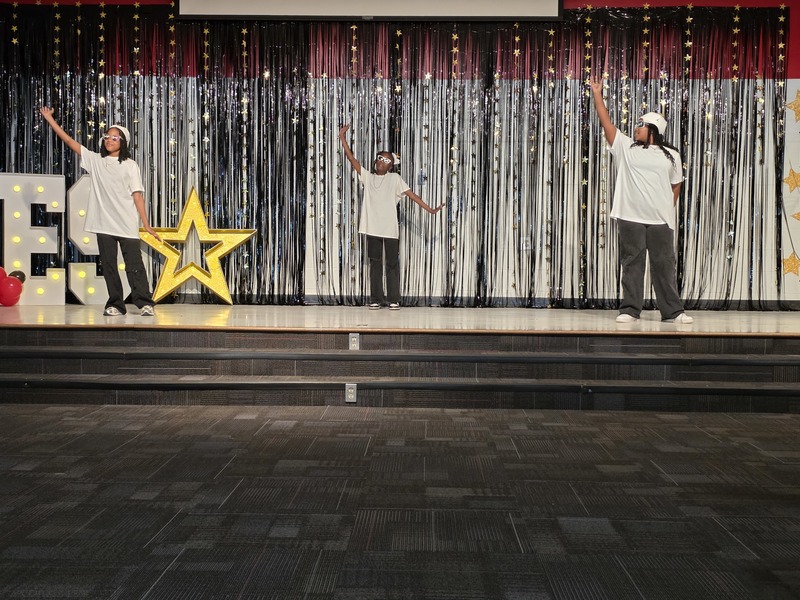 Students performing on stage.