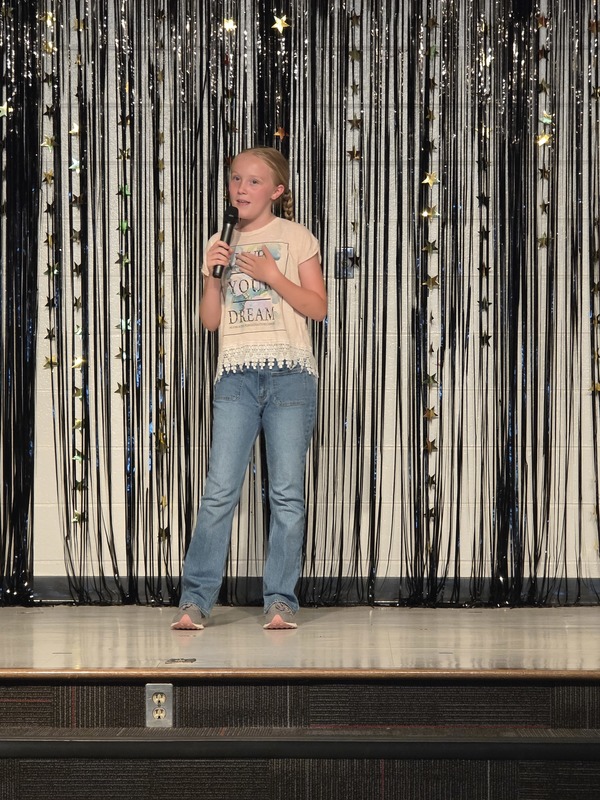 Students performing on stage.