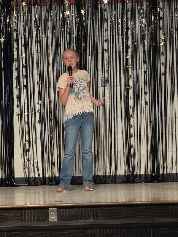 Students performing on stage.
