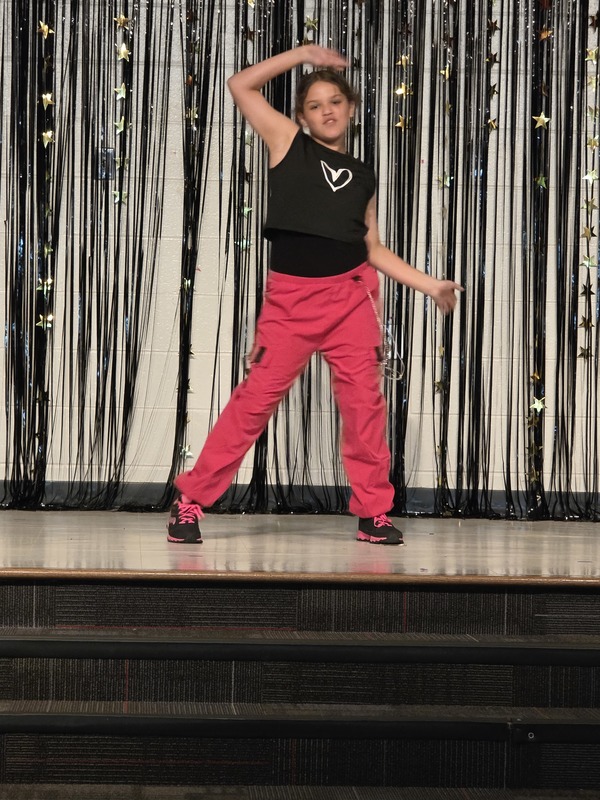 Students performing on stage.