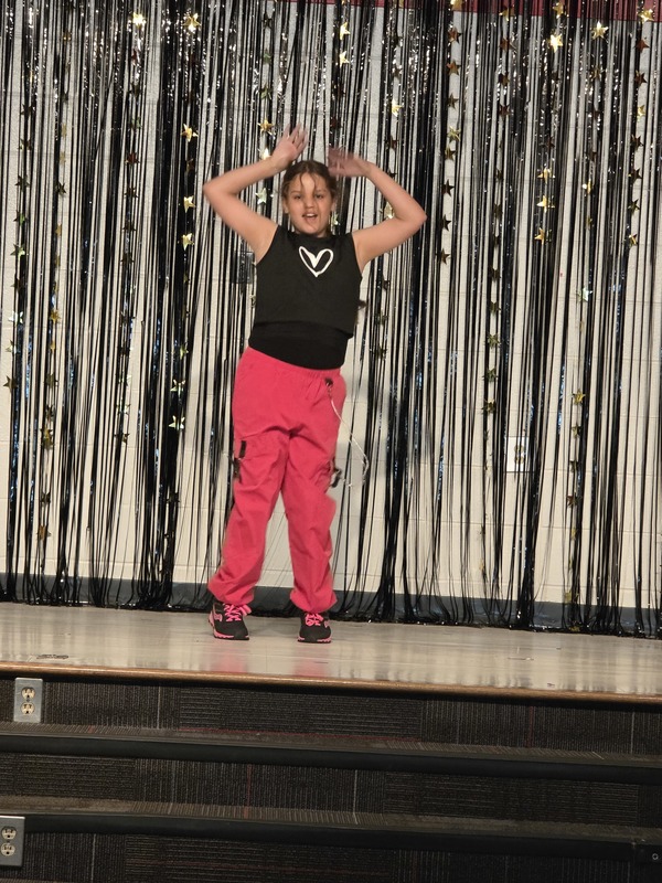 Students performing on stage.