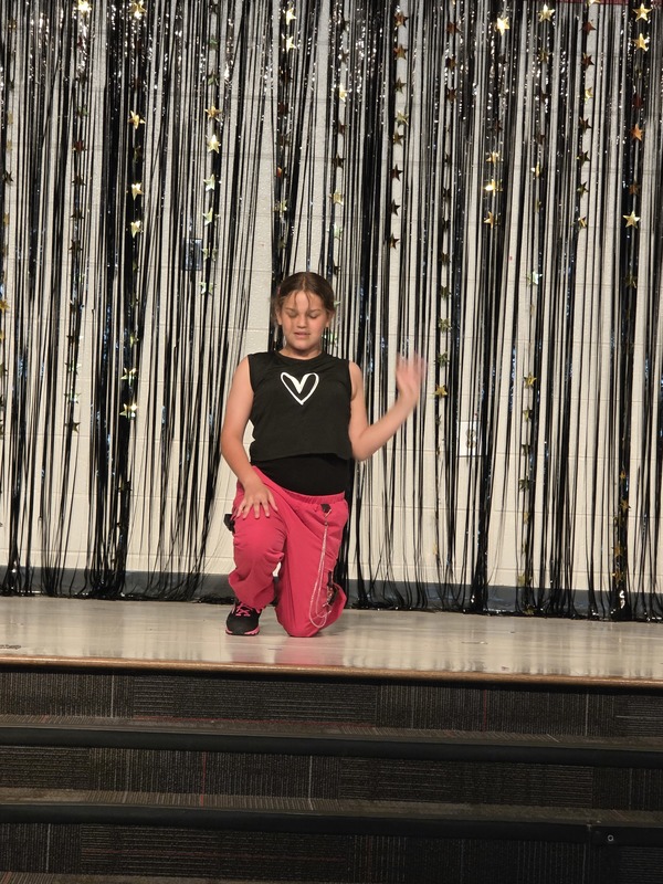 Students performing on stage.
