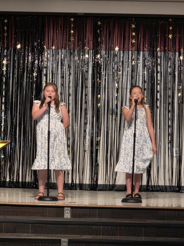 Students performing on stage.