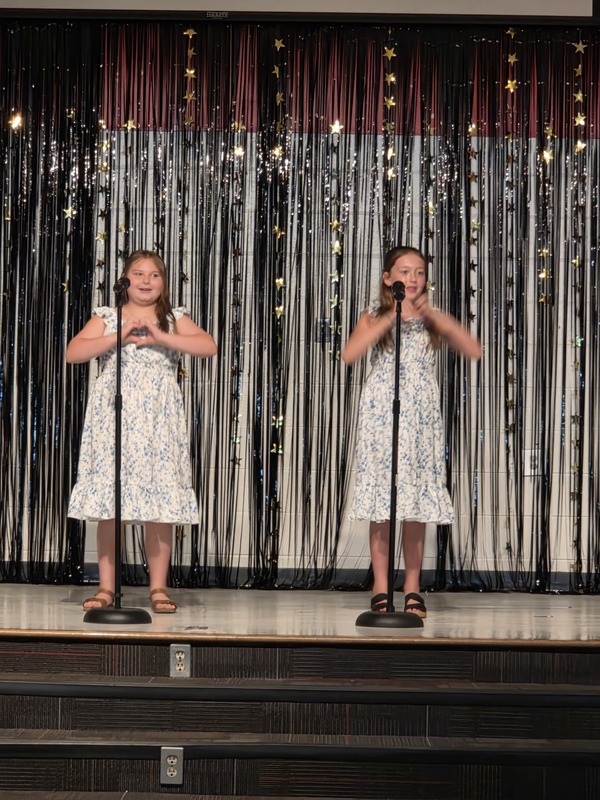 Students performing on stage.