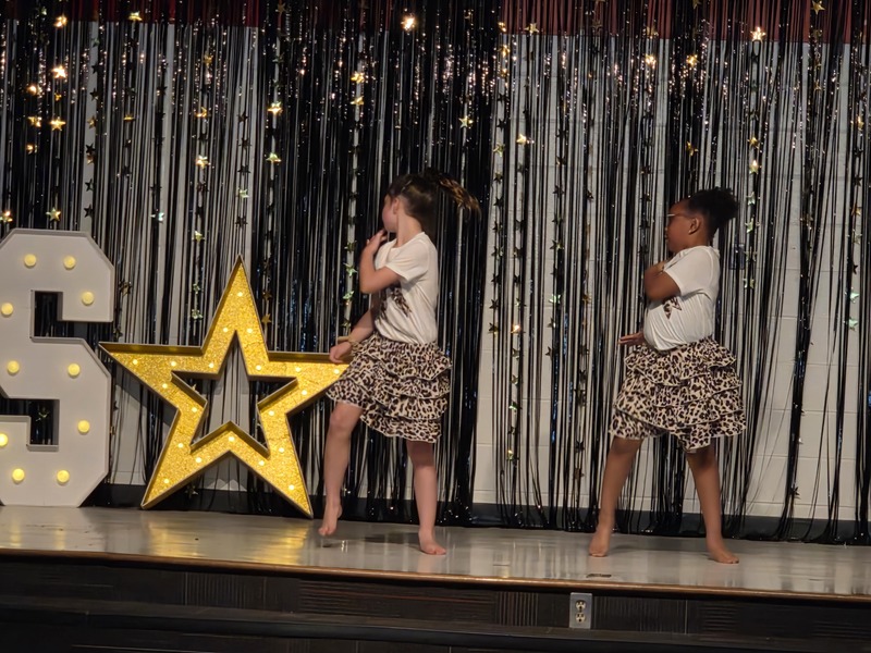 Students performing on stage.