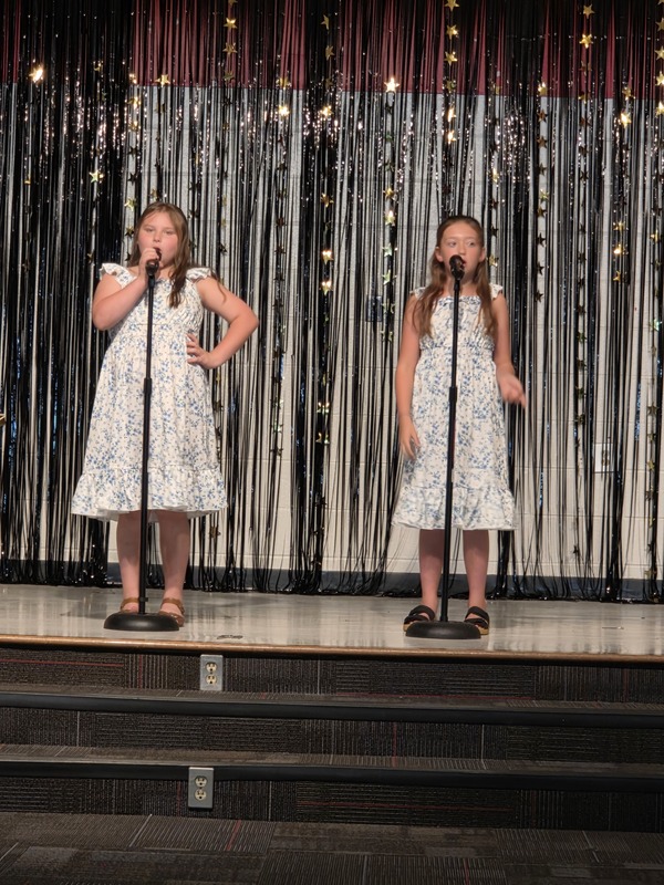 Students performing on stage.