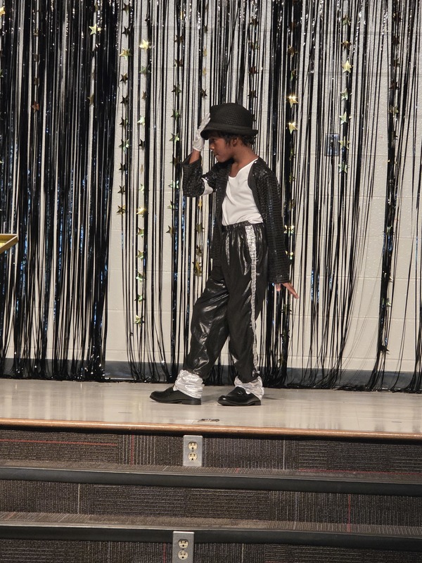 Students performing on stage.