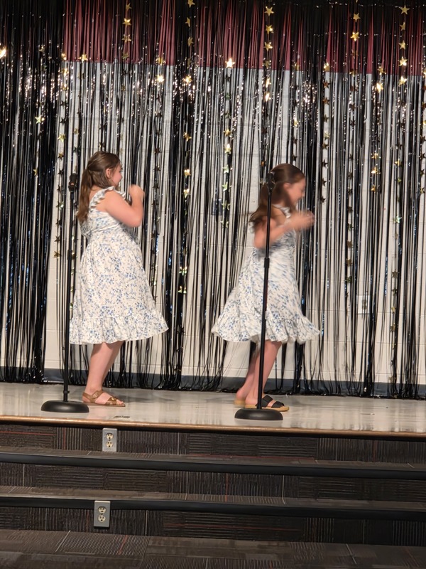 Students performing on stage.