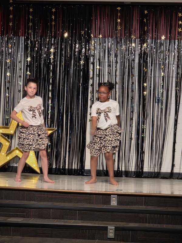 Students performing on stage.
