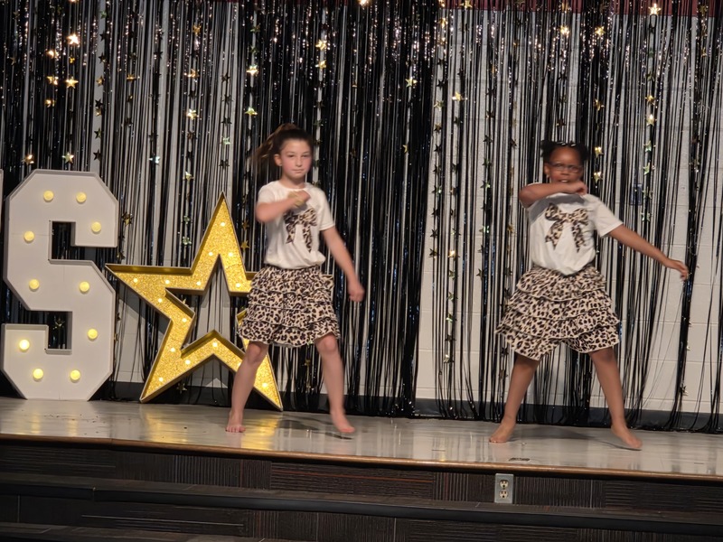 Students performing on stage.