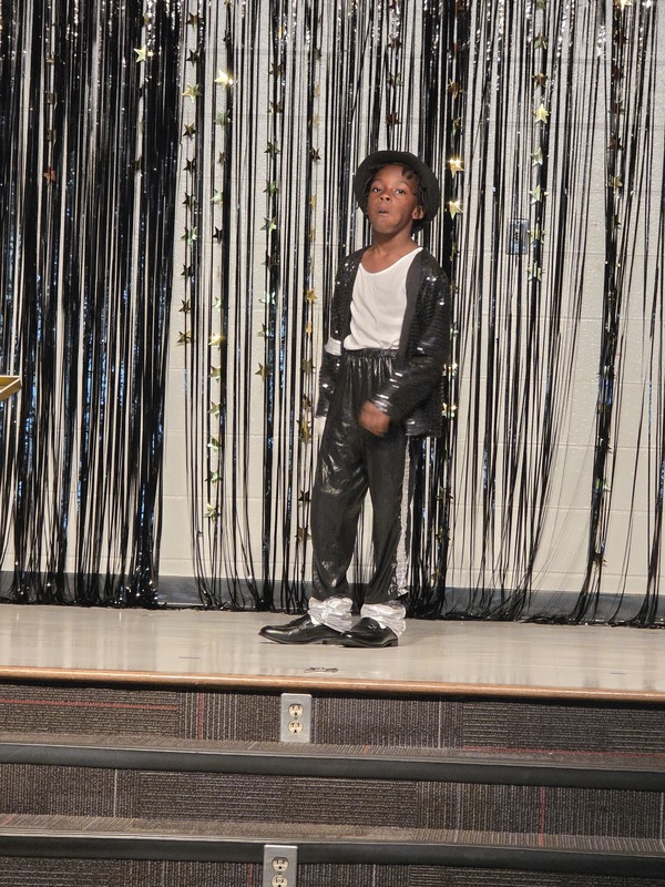 Students performing on stage.