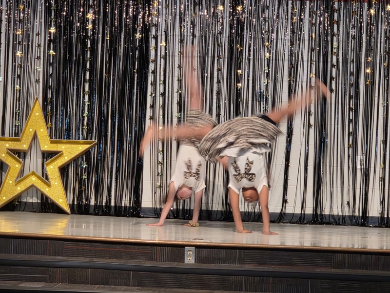 Students performing on stage.