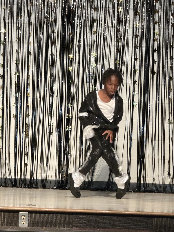 Students performing on stage.