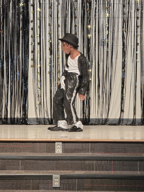 Students performing on stage.