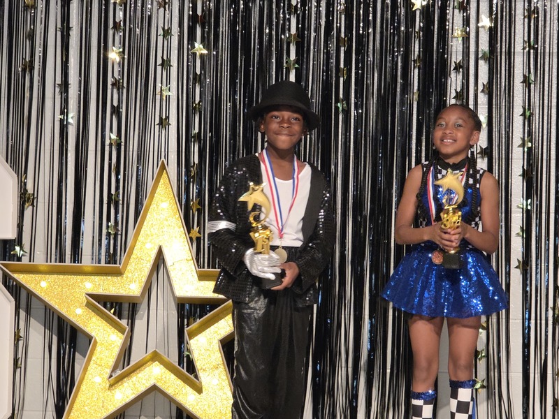 Winners being named and given trophies on stage.