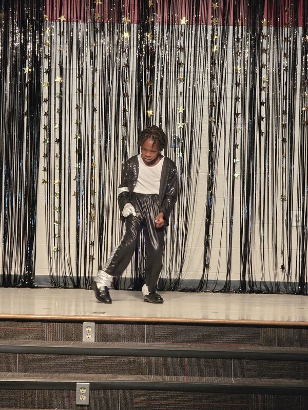 Students performing on stage.