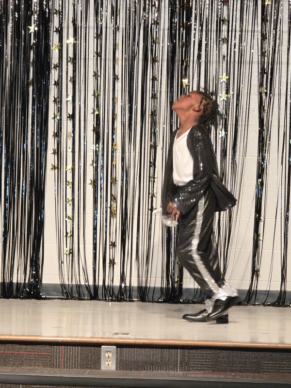Students performing on stage.