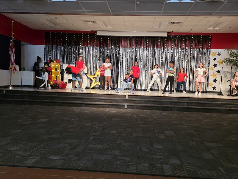 Students performing on stage.