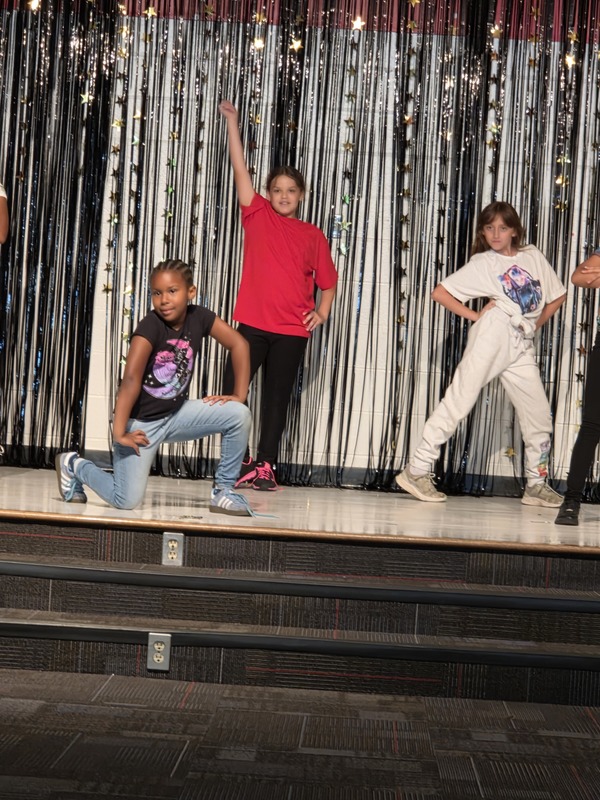 Students performing on stage.