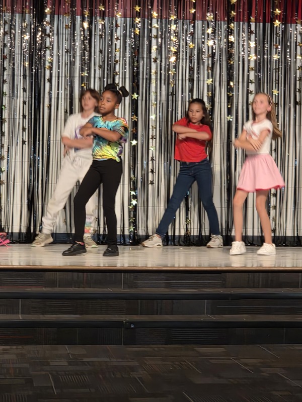 Students performing on stage.