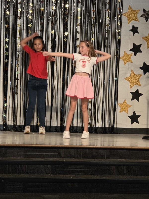 Students performing on stage.