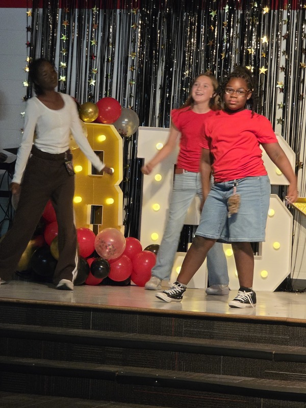Students performing on stage.