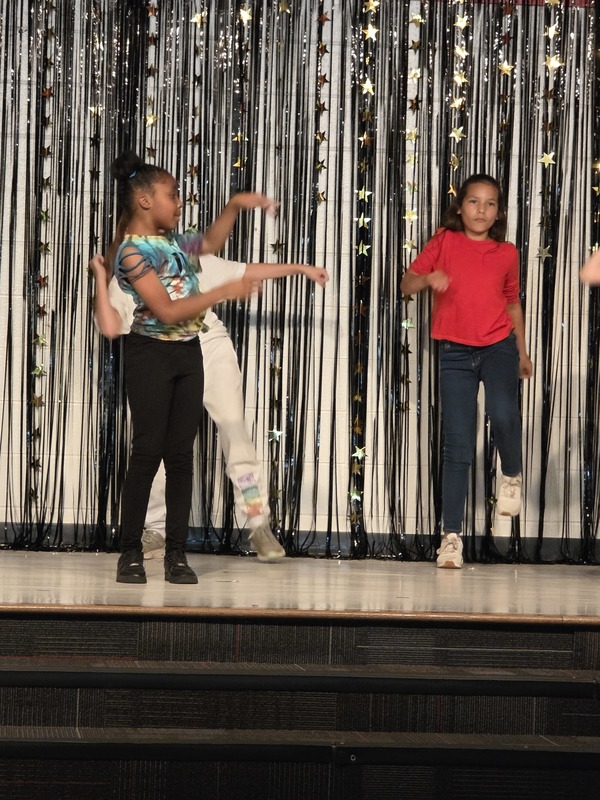 Students performing on stage.