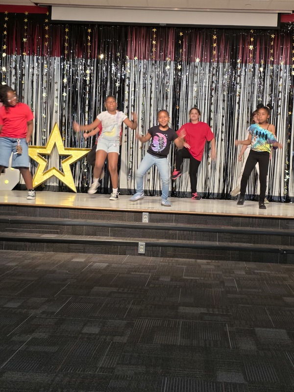 Students performing on stage.