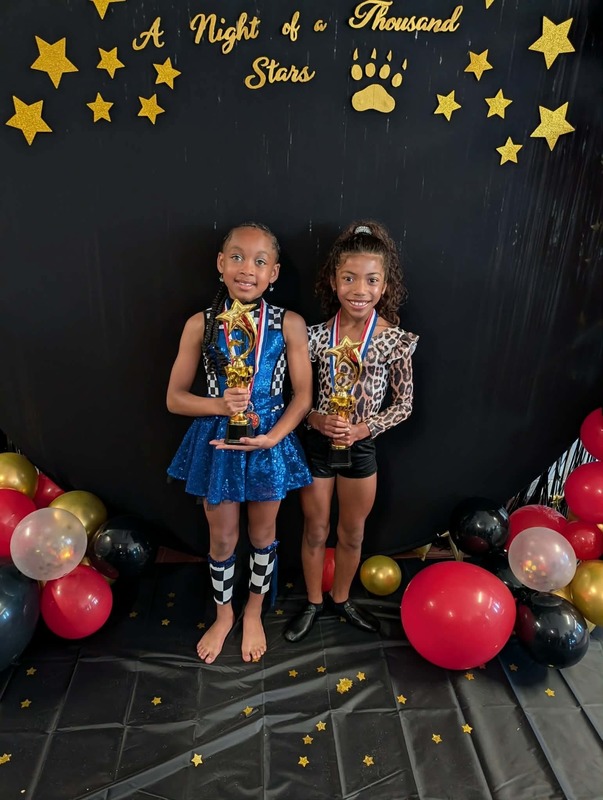 Performers with medals and trophies.