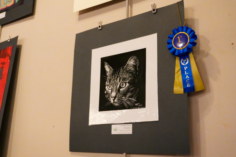 Scratch art depicting head of tabby cat.